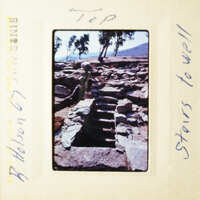 This is an old photograph of a stone staircase with a sign on top, taken during a trip to Greece.