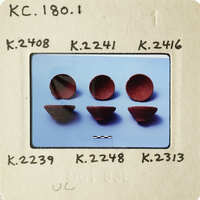 Five round objects on blue background.