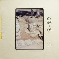 Old ruins with stone structures and dirt ground, possibly part of an archaeological site.