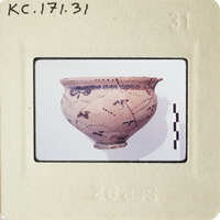 A photograph of an ancient Greek vase with black-figure pottery technique.