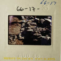 The photo shows an old, worn-out brick wall with some stones missing, possibly indicating age and weathering.