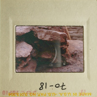 A photo of a rocky landscape with a small hole in the center.