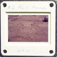 A photograph showing an excavation site with dirt and rocks, possibly part of an archaeological dig.