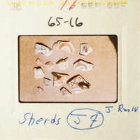 A collection of broken pottery pieces on a table.