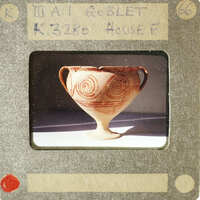 Ancient Greek vase with swirling patterns.