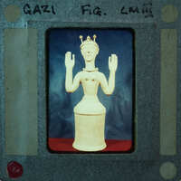 A small figurine of a person with a crown, placed on top of a cylindrical base.