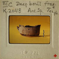 Ancient Greek vase with intricate designs, displayed on a light yellow background.