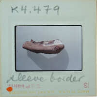 Terracotta tubular fragment on white surface K4.479.