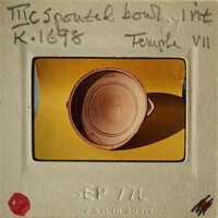 Ancient Greek vase on display with information label.