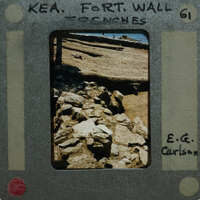 A photograph of a rock wall with film strip borders and information about the location and photographer.