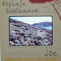 This is a photograph of a rocky coastline with a body of water, possibly an ocean or sea.