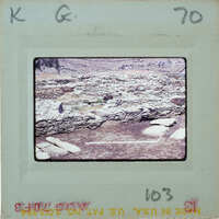 A photograph of a stone structure on a film strip.