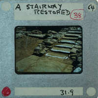 A photograph of a set of stone stairs with an attached negative strip and label.