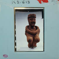 Terracotta figurine fragment (K3.613) from front showing head and torso.