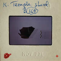 A photograph of an ancient artifact, possibly a bowl or pottery piece, with annotations and labels indicating its historical significance.