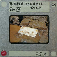 A photograph of a dirty baseball glove on a muddy surface, with handwritten notes indicating it's from the Temple Marble Mine.