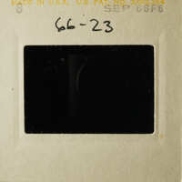 Black and white photo of an open film cartridge with a label on it.