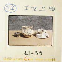 Two pictures of pottery displayed on a table.