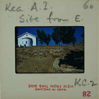 A vintage postcard with a photo of a church on a hilltop, featuring handwritten notes and stamps.