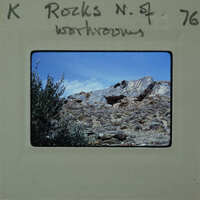 A vintage film strip with a mountainous landscape scene.