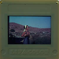 Picture of a woman in a village setting, with the Polaroid brand and "LIFE COLOR" label visible.