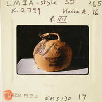 A photograph of an ancient clay pot with intricate designs.