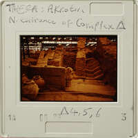 Ancient ruins with stone steps and columns, captured on a vintage film strip.