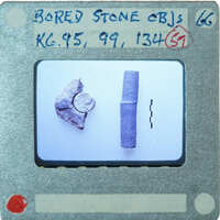 Three broken stone objects on table, K6.95, K6.99, K6.134.