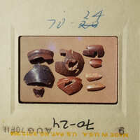 The images show an assortment of broken pottery pieces on a tray, with some larger pieces and smaller fragments.