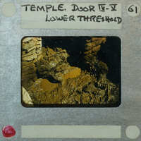 Detail of muddy floor and stone walls with slide label "Temple. Door IC-V Lower Threshold."