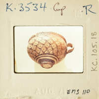 Ancient Greek vase with intricate designs and patterns, photographed on a white background.