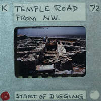 Parallel wall with surface between them and water in the background.