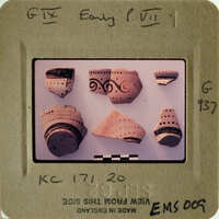 A collection of ancient pottery shards with intricate designs on them.