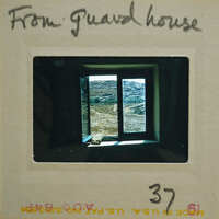 A photograph of a window with a view, displayed on a film strip.