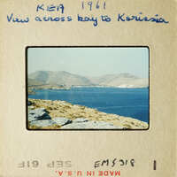 Landscape view with mountains and water, possibly from an old travel photo.