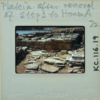 Old photograph of a stone structure with handwritten notes on the border.