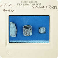 Old ceramic fragments on blue paper with measurements and labels.