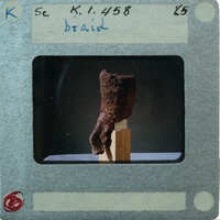 Terracotta figurine hair braid from 3/4 view K1.458.