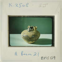 Ancient vase with intricate designs on display.