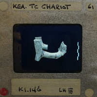 Broken terracotta fragment (K1.146) white with painted decoration.