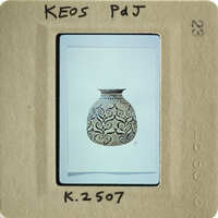 An antique vase with intricate patterns, captured on an old photograph.