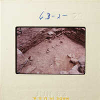 Ancient ruins with stone walls and rubble, captured on a vintage film strip.