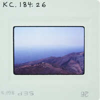 A photograph of a mountainous landscape with a clear sky.