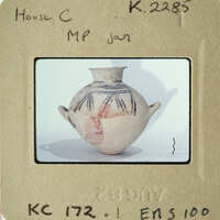 A photograph of an antique vase with intricate patterns and colors.