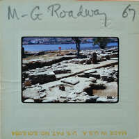 An old photograph of a historical site with ruins and a body of water in the background, labeled "M-G ROADWAY" and dated "37".