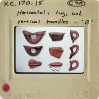 Old clay artifacts with handles, displayed on a white background.