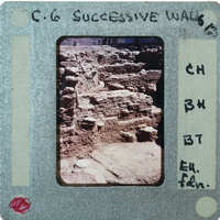 A photograph of an old brick wall with a white border and handwritten notes on the bottom.