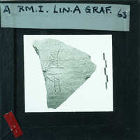 Pottery fragment with writing carved into it.