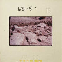 Pile of rocks on dirt ground.