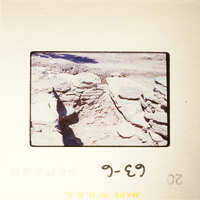 Ancient ruins with visible stone structures and shadows.